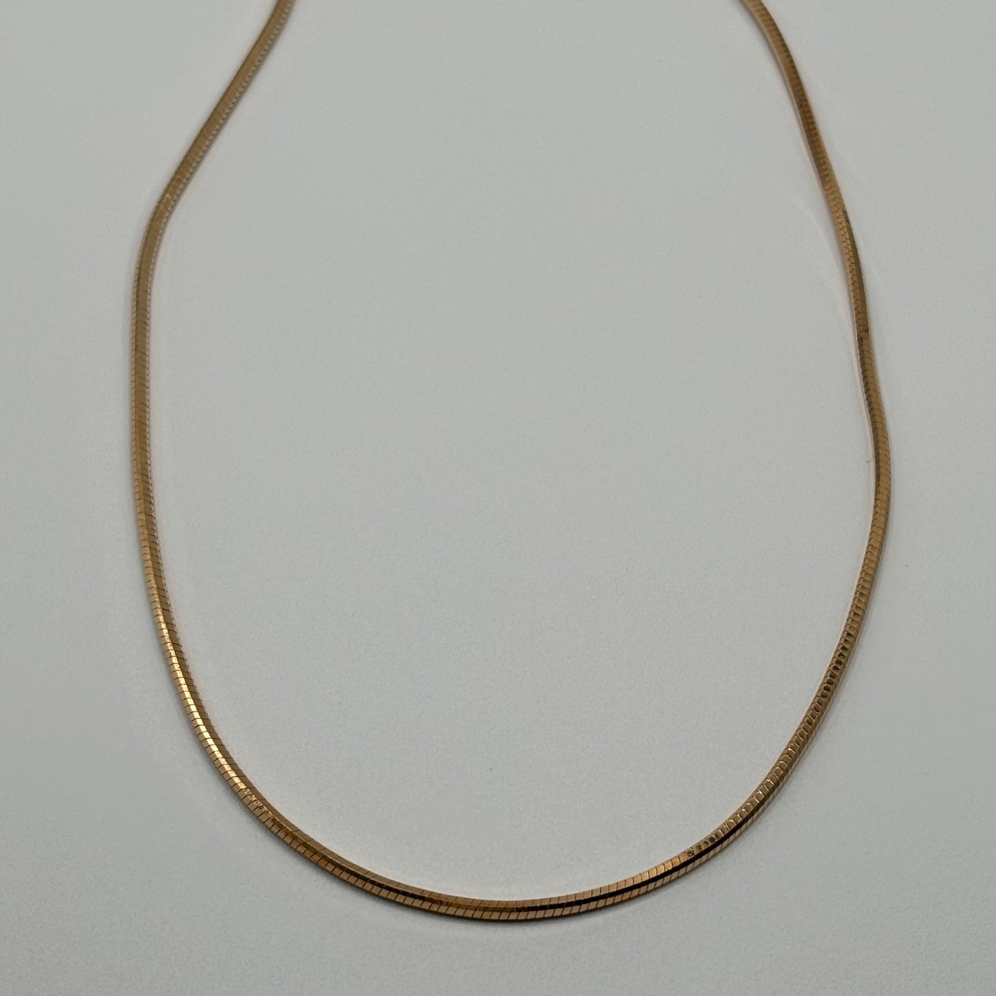 Silken Gleam: The Smooth Golden Omega Necklace