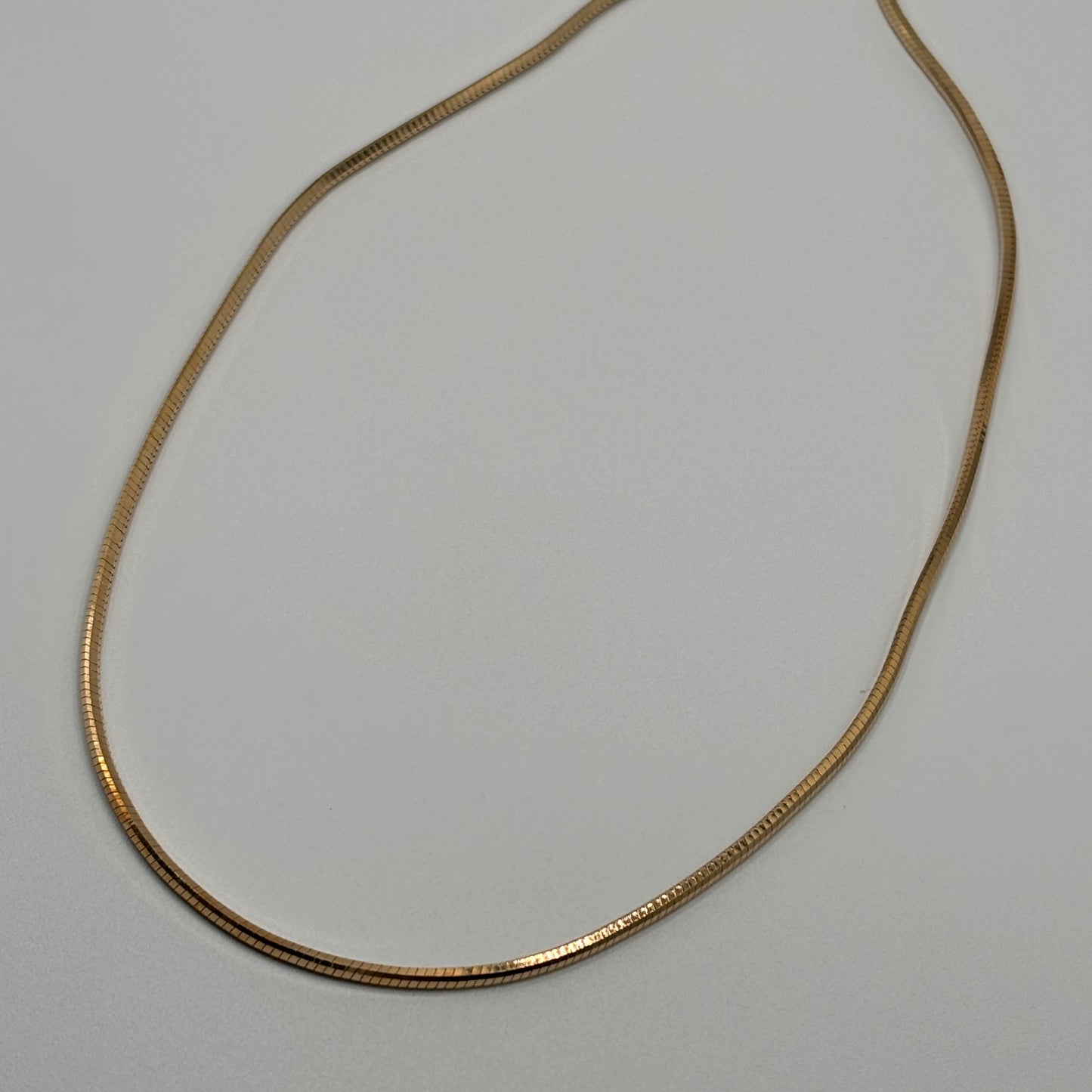 Silken Gleam: The Smooth Golden Omega Necklace