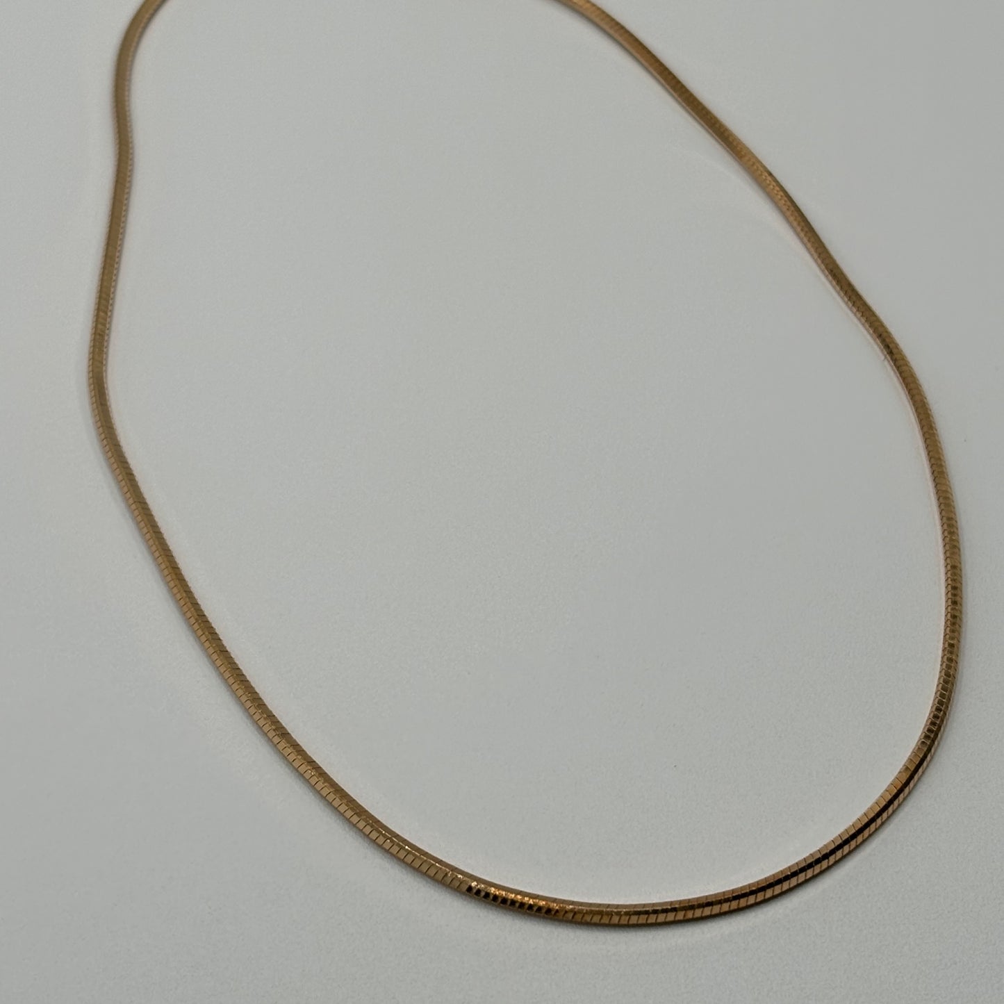 Silken Gleam: The Smooth Golden Omega Necklace