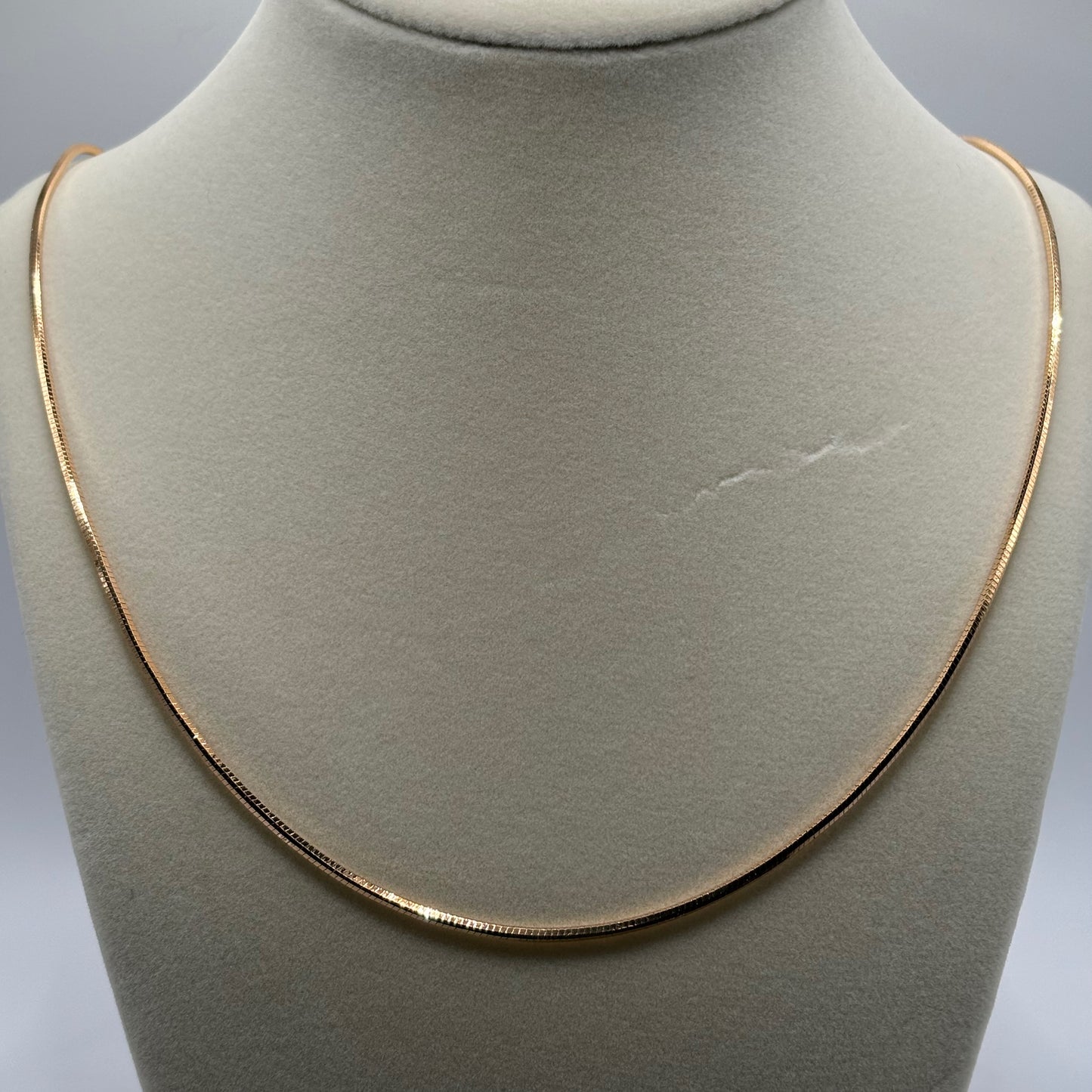 Silken Gleam: The Smooth Golden Omega Necklace